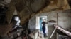 Russia -- A local resident looks at the debris of a house damaged by floods in the town of Krymsk in Krasnodar region, 08Jul2012